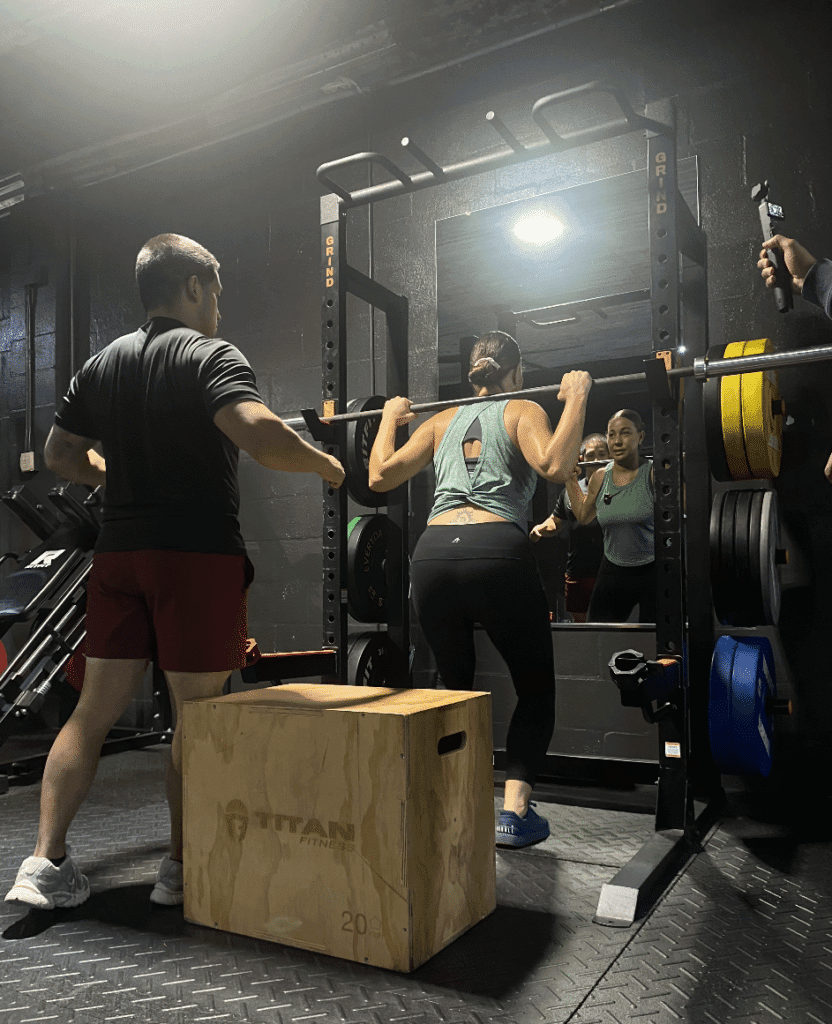 Client at Prime Strength And Conditioning lifting barbell.